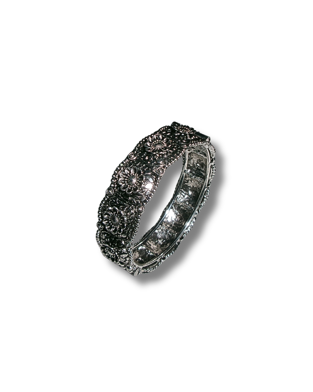 A silver band ring featuring intricate floral and scrollwork pavé settings, photographed on a clean white background with a soft drop shadow.