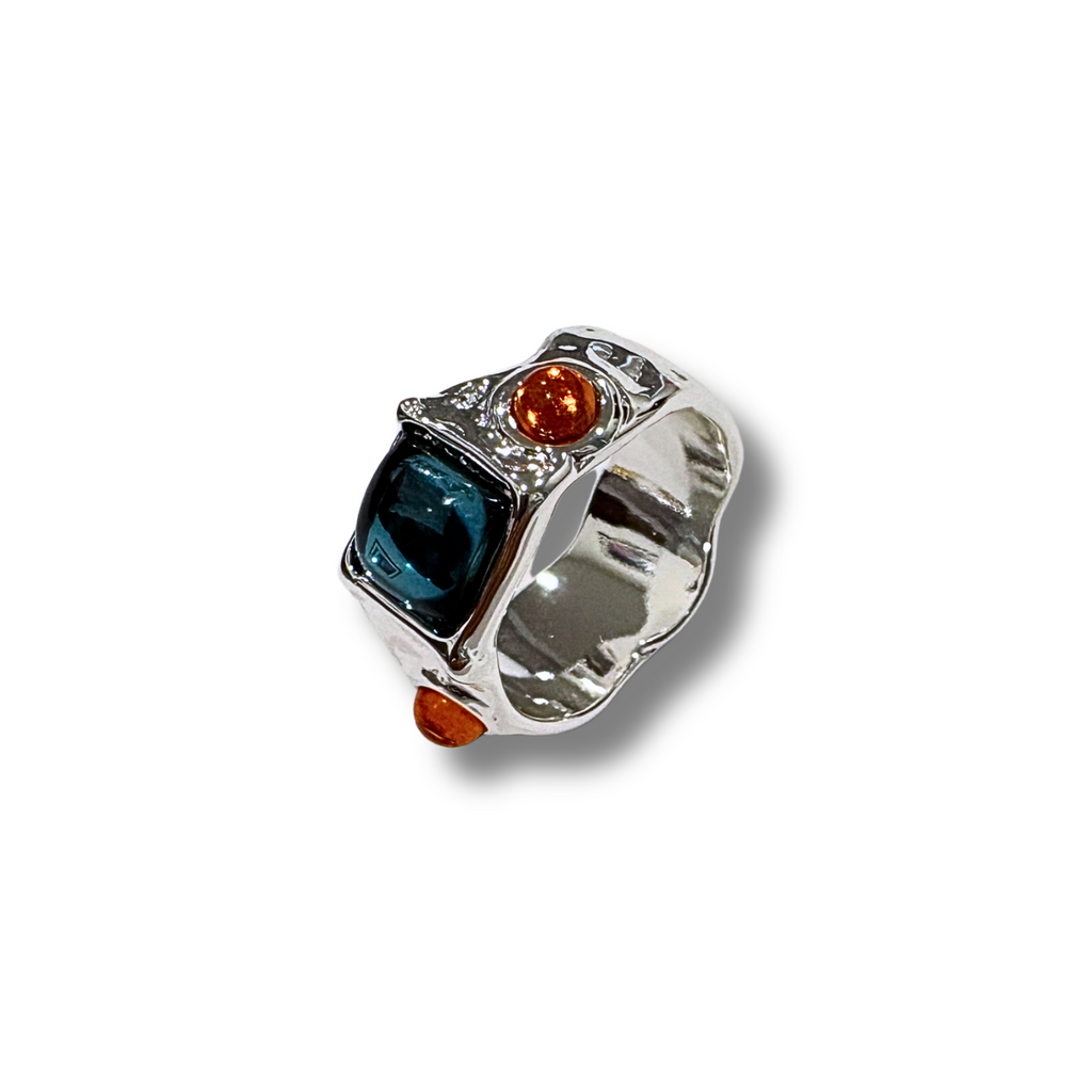Silver ring with colored stones on a white background