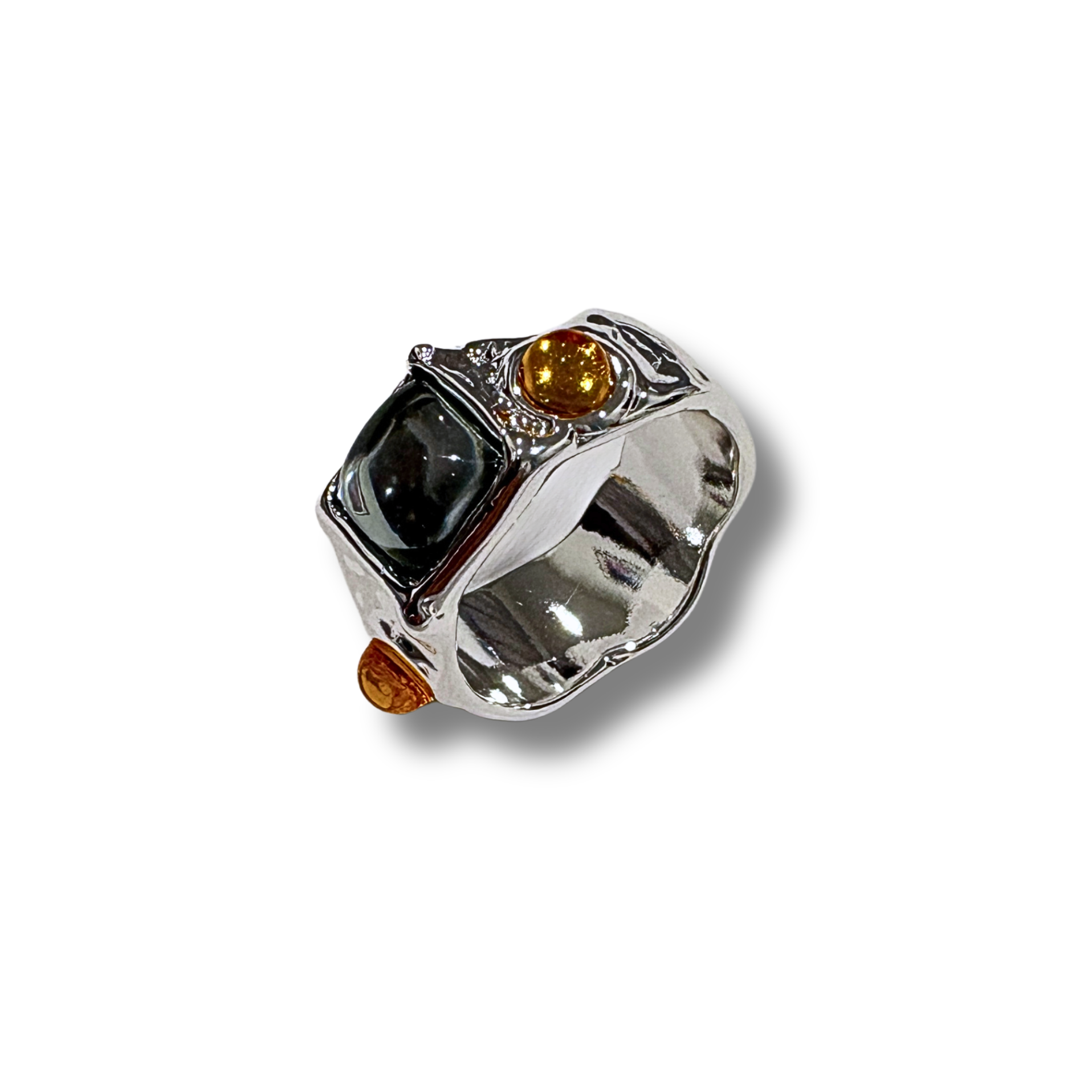 Silver ring with black and orange gemstones on a white background