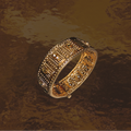 Decorative gold bracelet on a textured brown background