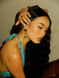 girl wearing blue dress and gold jhumkas