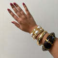 hand wearing gold resin bangle